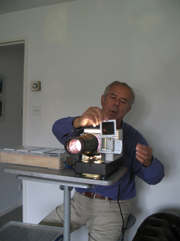 Robin Dale operates his slide projector. 
