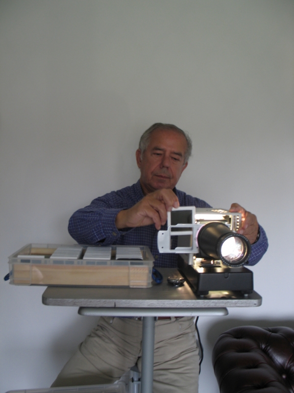 Robin Dale operates his slide projector. 
