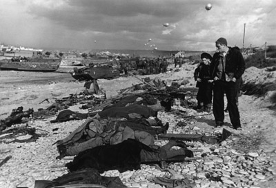 French fishermen with the bodies of men killed during the D-Day landings, Omaha Beach, June 1944 by Robert Capa